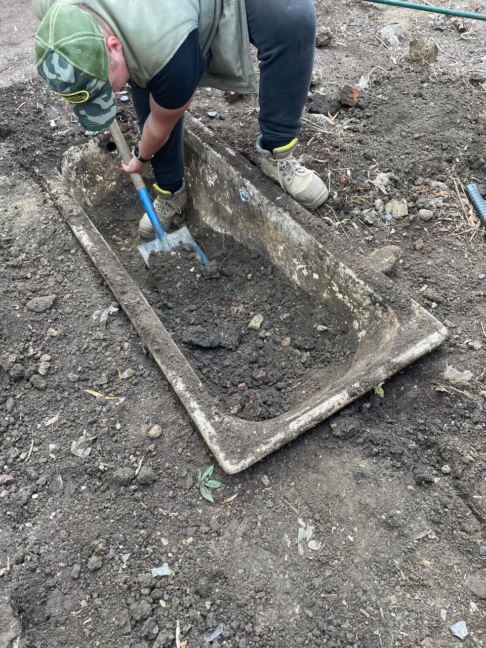 Digging out an old concrete planter base by hand