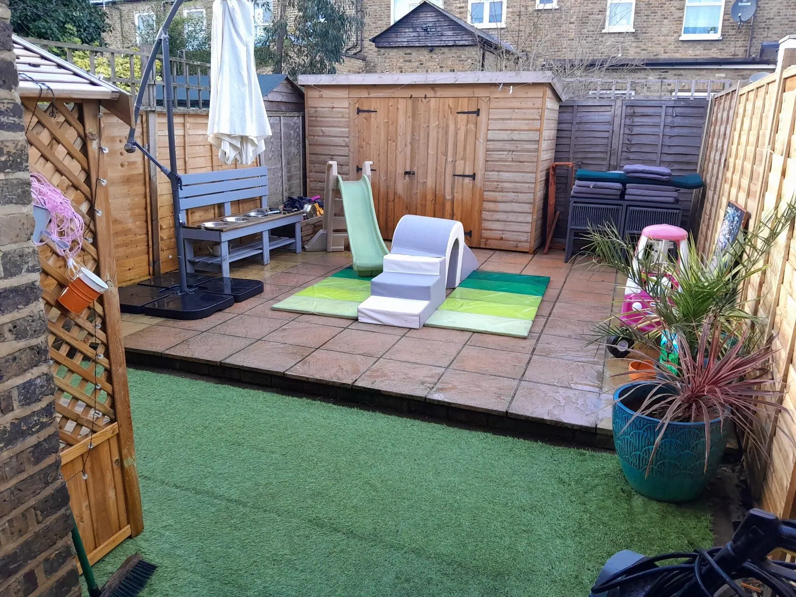 Small family garden with artificial grass and patio tidied