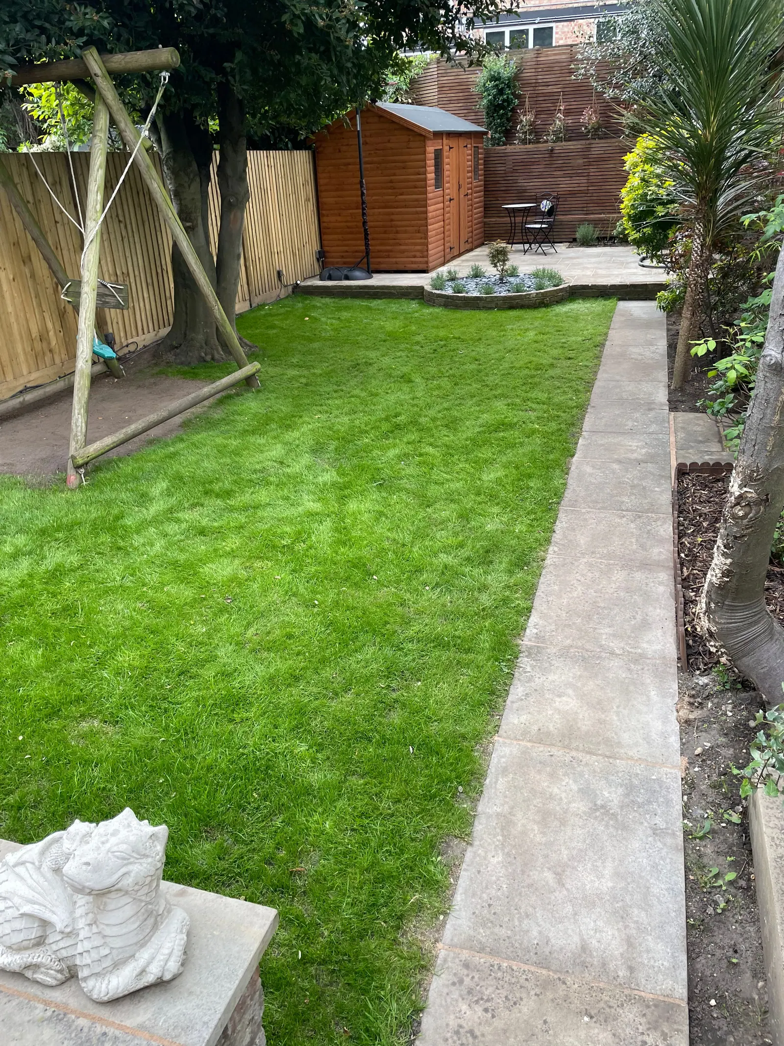 The same garden with the new lawn established, new fence and shed